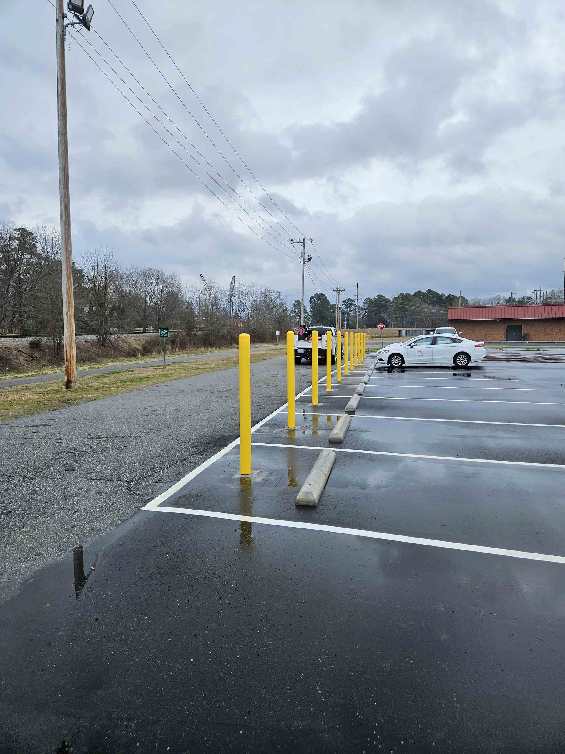A parking lot with cars parked in it on a rainy day