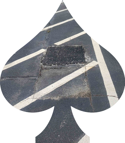 A spade shaped hole in a parking lot