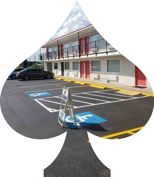 A spade shaped parking lot with a handicap sign