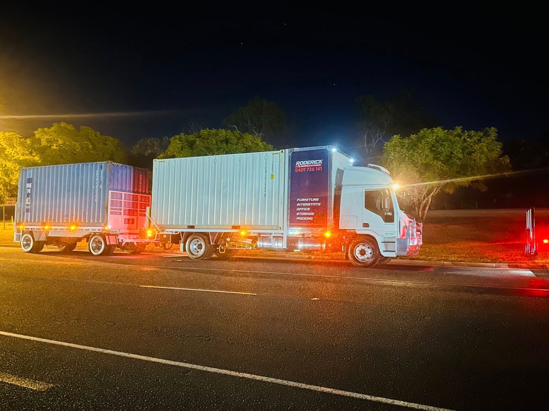 Truck With Two Trailers, Illuminated at Night on a Road