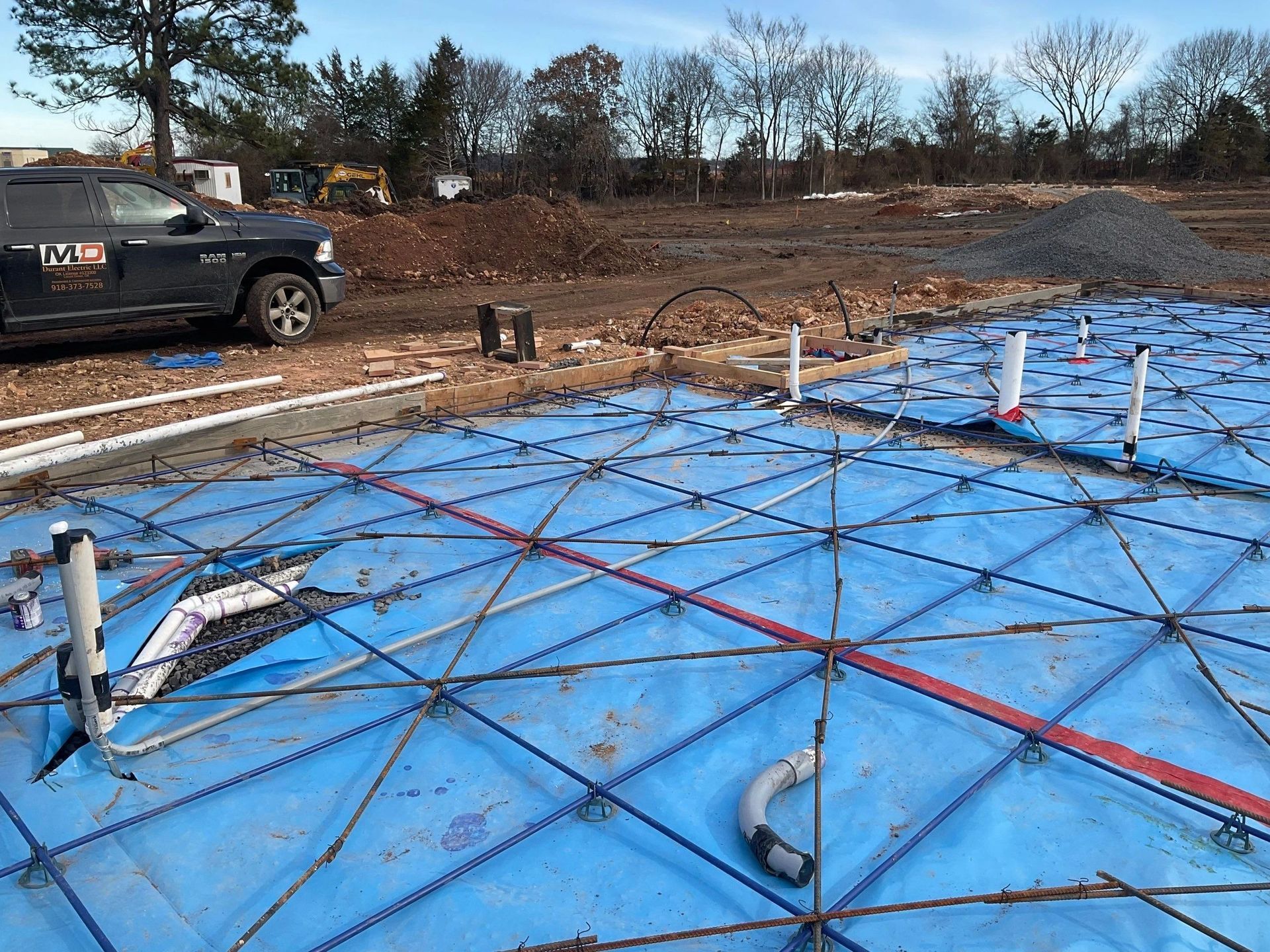 A truck is parked on the side of a construction site.