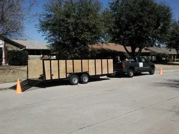 A truck and trailer are parked on the side of the road
