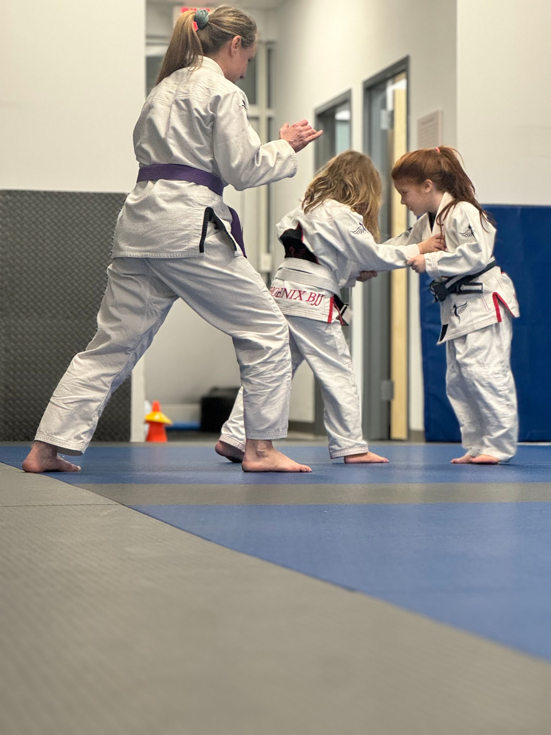 Kids practice Brazilian Jiu-Jitsu drills at Phoenix Brazilian Jiu-Jitsu and Martial Arts School.