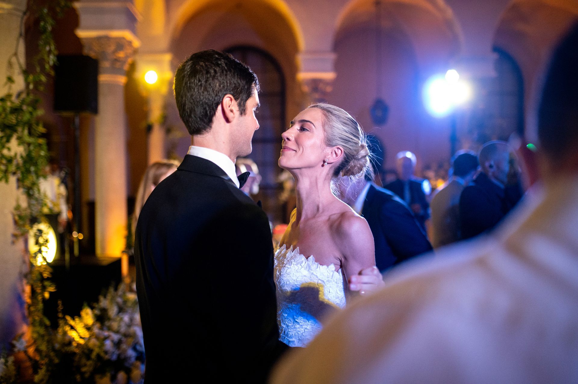 A bride and groom are dancing at their wedding reception.