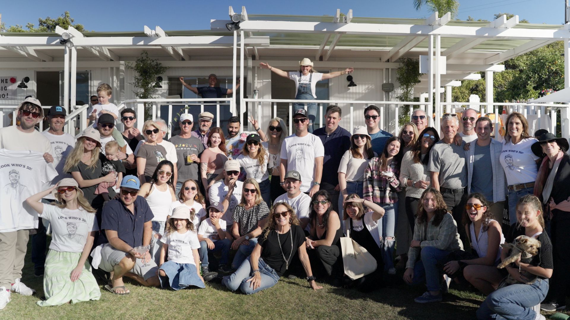 Private party group photo in front of farm house and deck