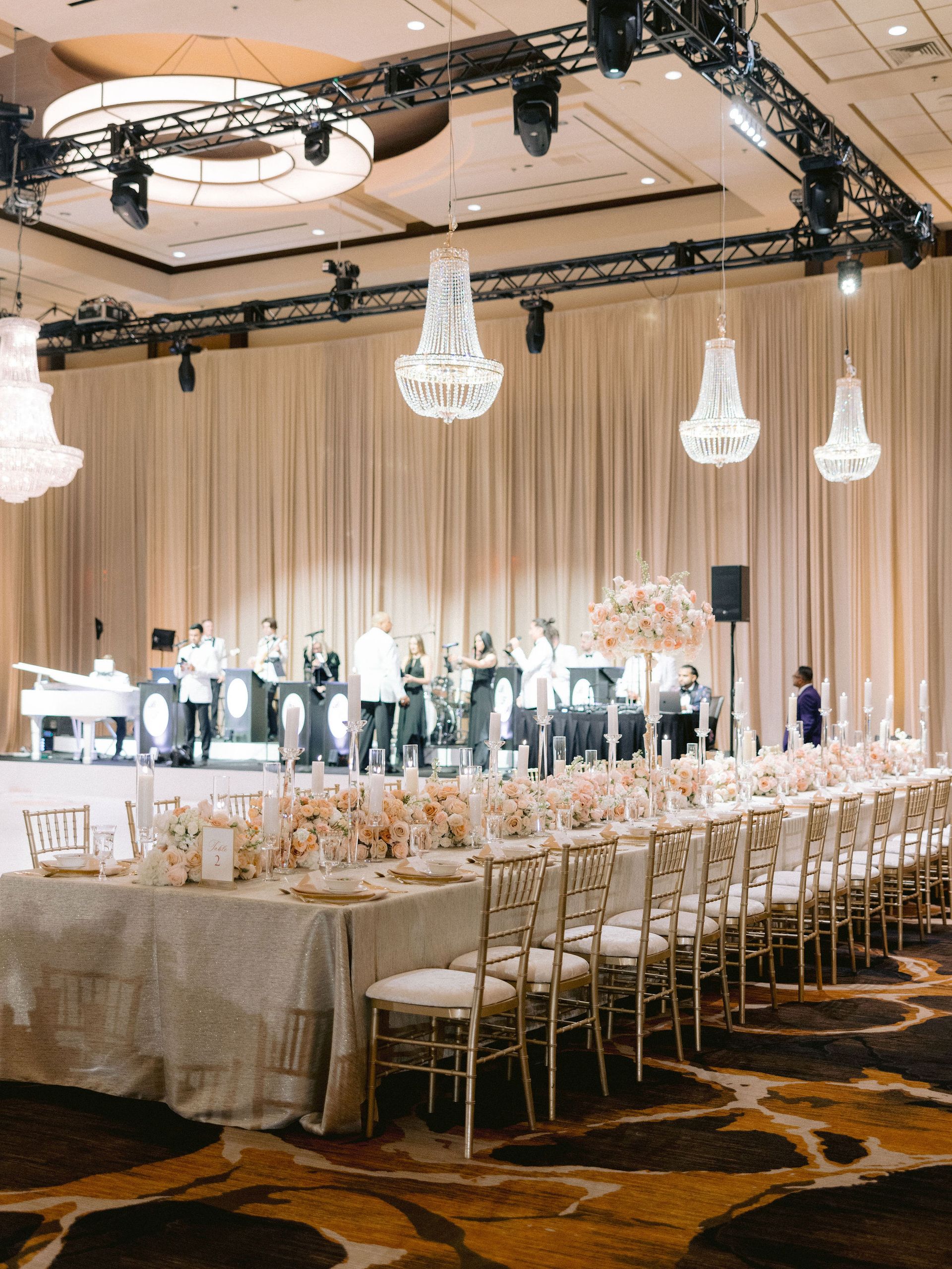 A large room with tables and chairs set up for a wedding reception.