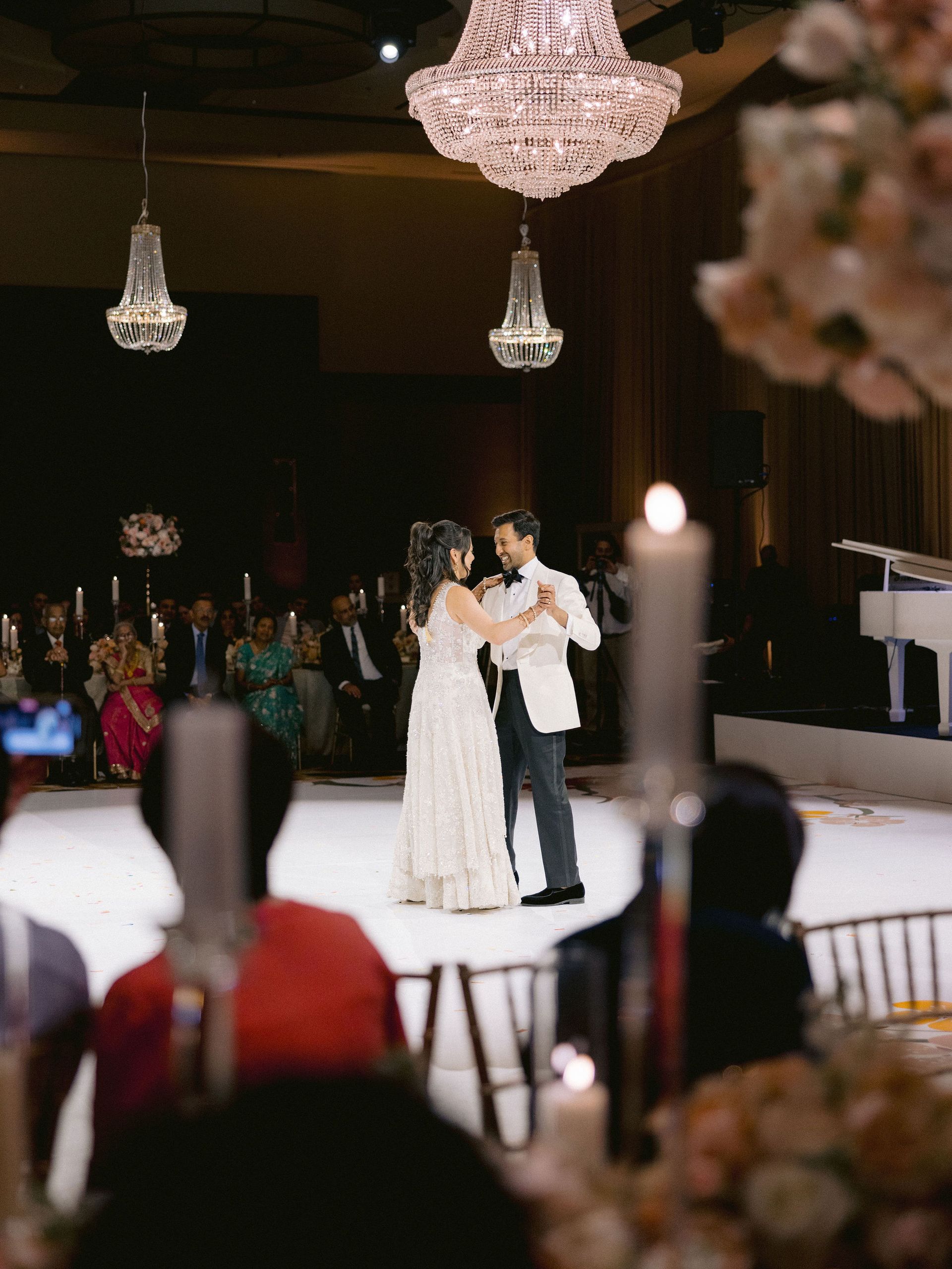 A bride and groom are dancing at their wedding reception