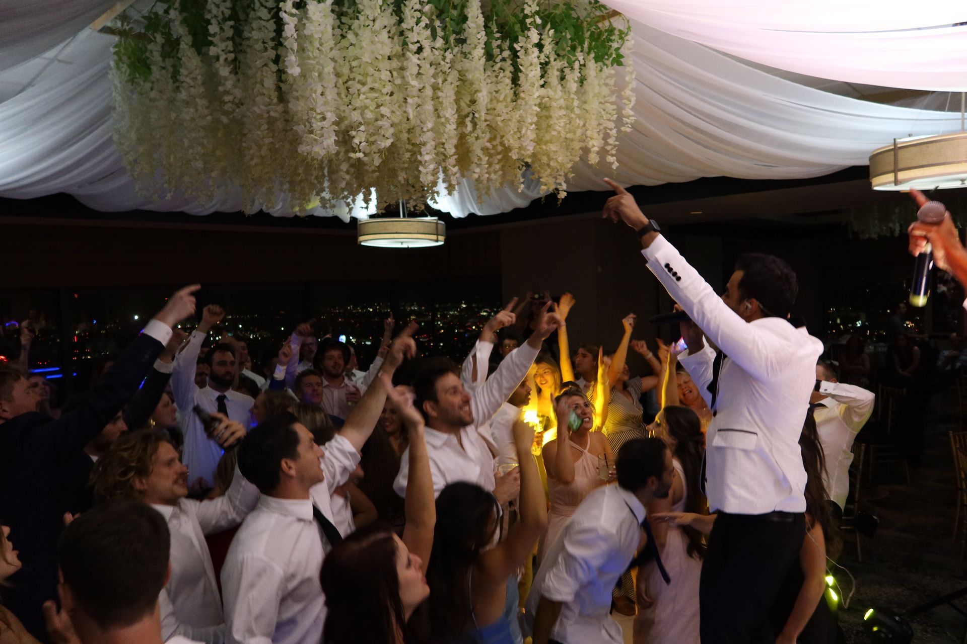 Lead singer hyping up crowd at wedding reception