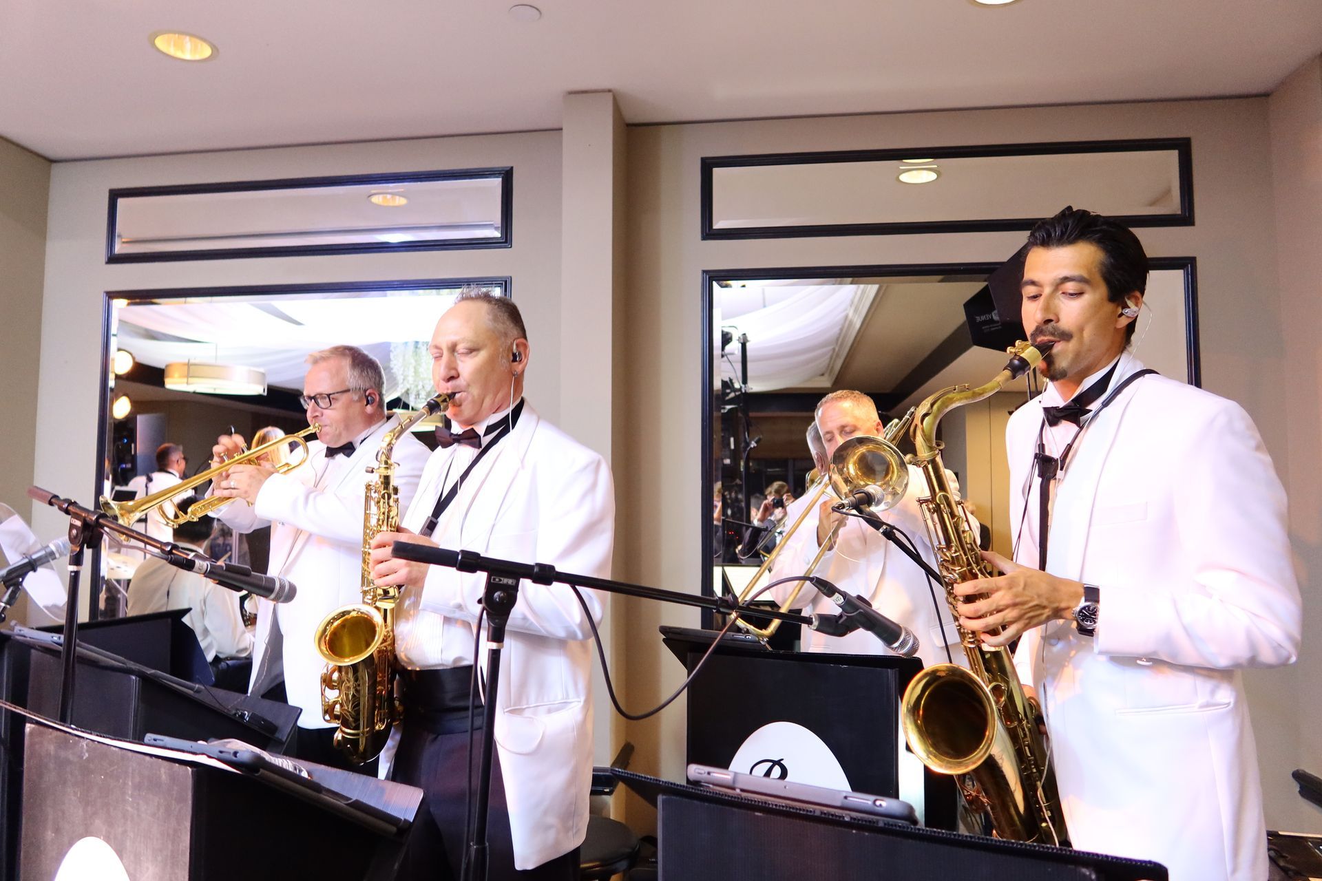 Saxophone and trumpet players performing at private event