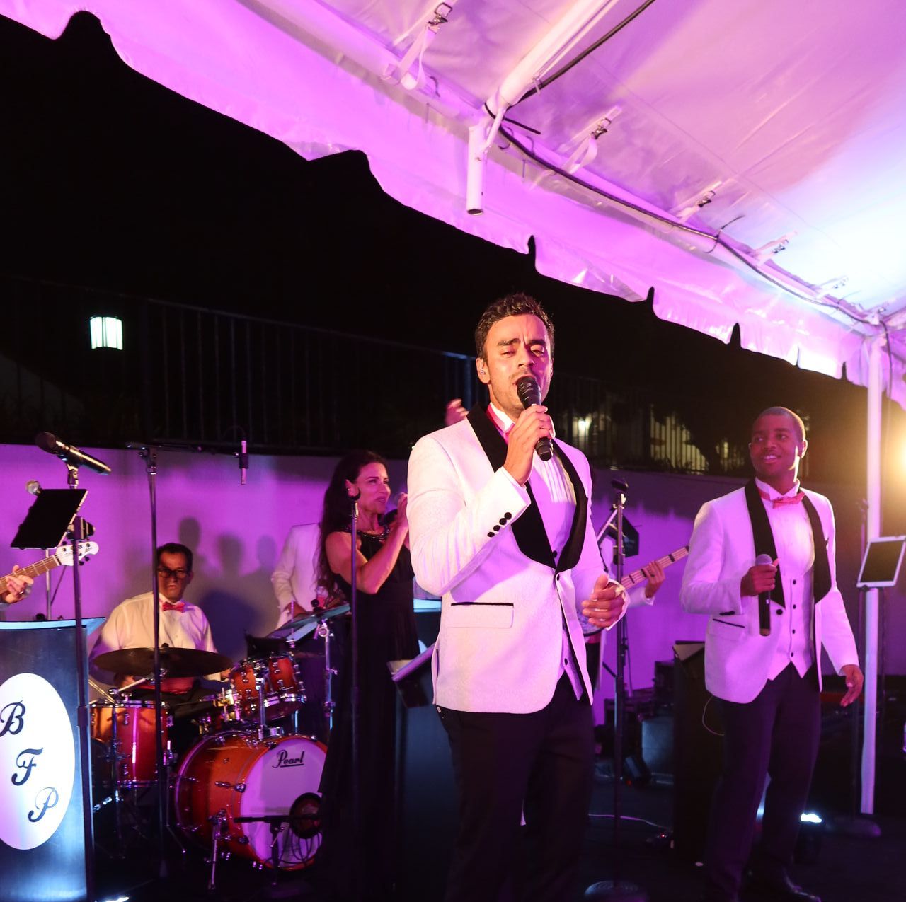 Lead singer performing with purple uplighting
