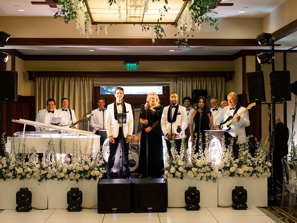 Bonnie Foster and band with instruments at wedding reception with flowers