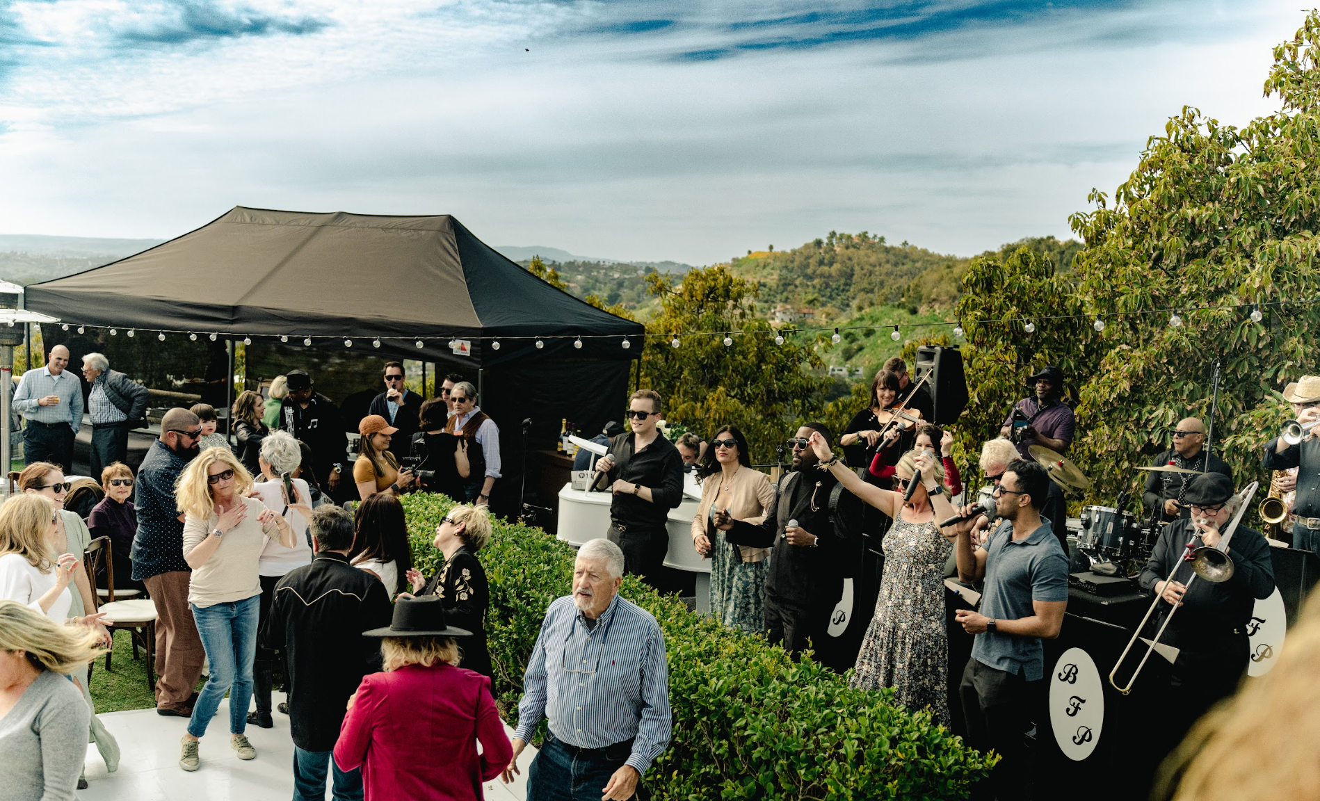 Bonnie Foster Productions live brand at outdoor celebration with food tent