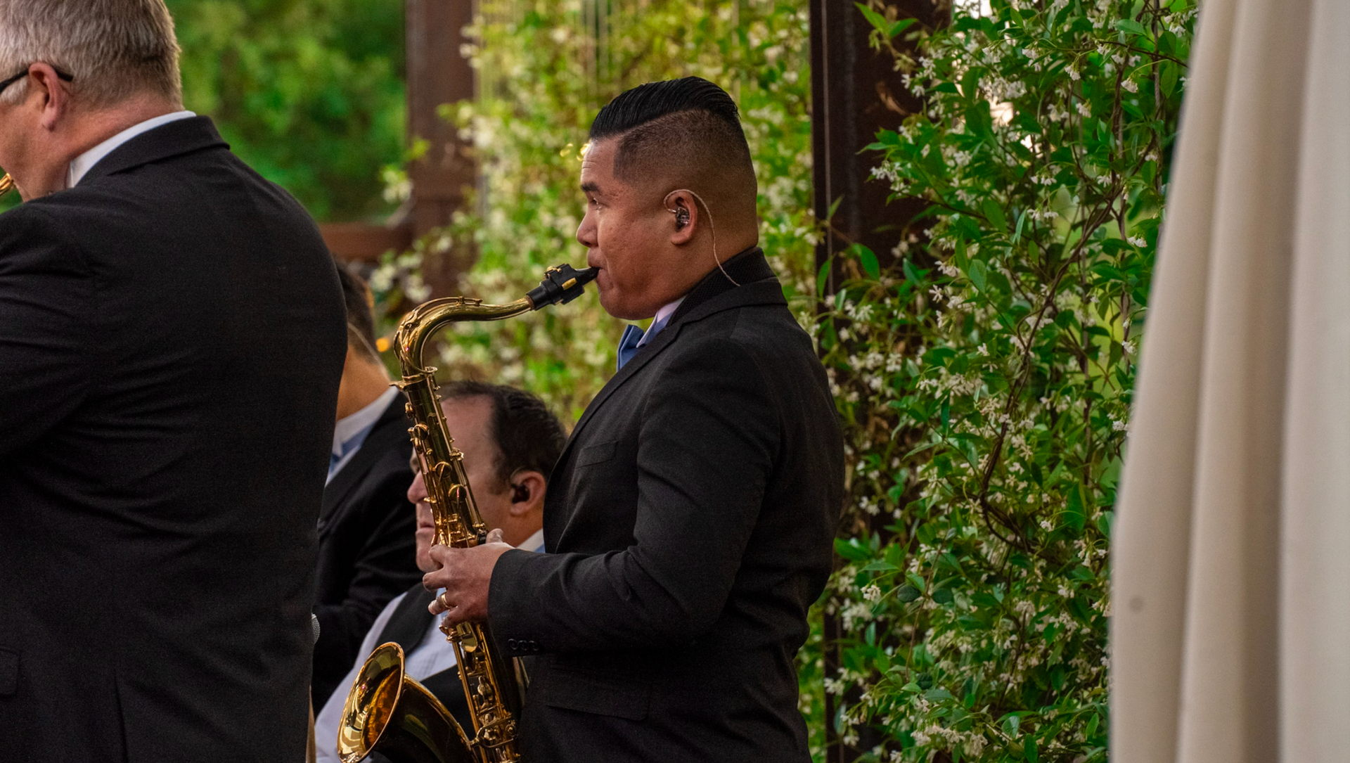 saxophone player in garden venue