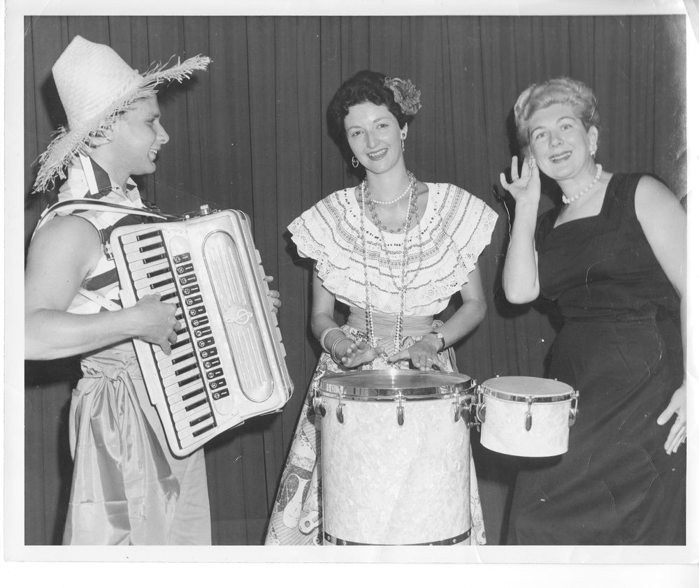 Marin Foster and performers with instruments in front of curtain backdrop