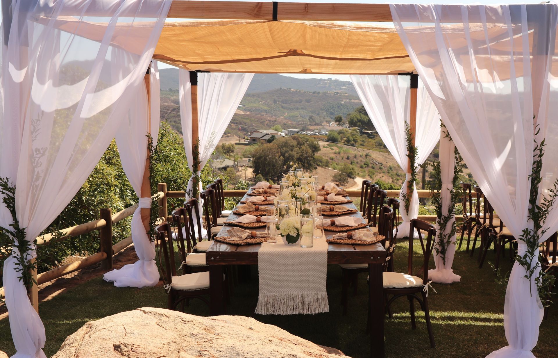 Table setting and covered pergola for intimate wedding