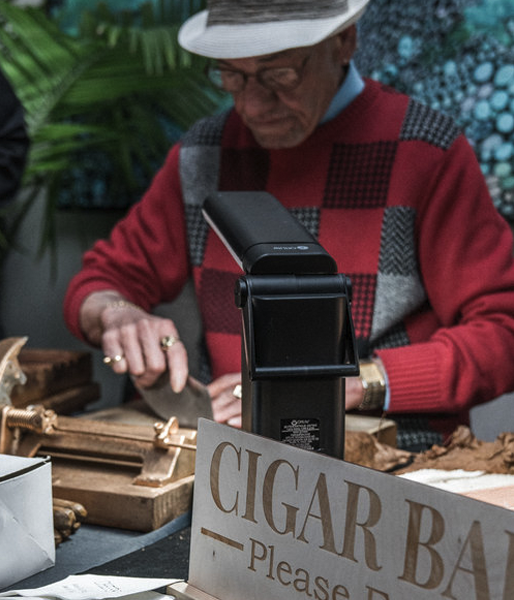 Private event cigar bar with man rolling fresh cigar