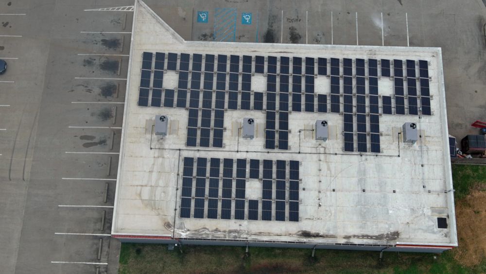 Solar panels on a building rooftop; overhead view.