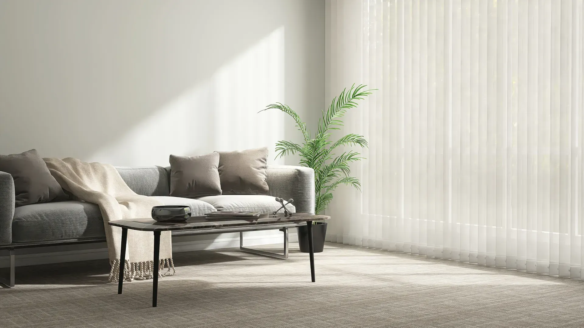 Bright living room with a gray sofa, beige chairs, coffee table, and a plant by sheer curtains.