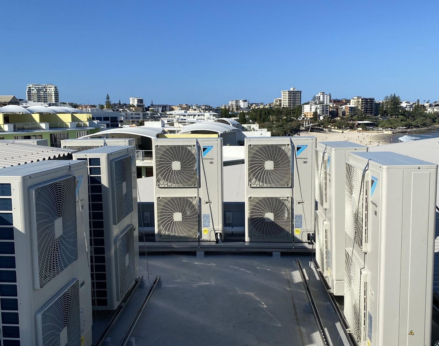A Bunch of Air Conditioners Are Sitting on Top of a Building — Comfort Solutions in Buderim, QLD