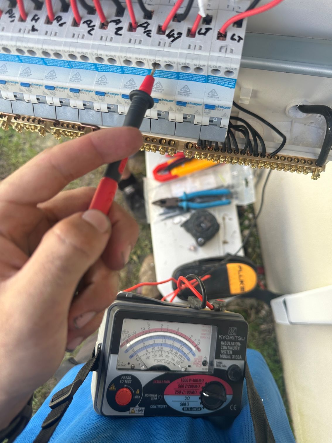 A Person is Using a Multimeter to Test a Circuit Board — Comfort Solutions in Kunda Park, QLD