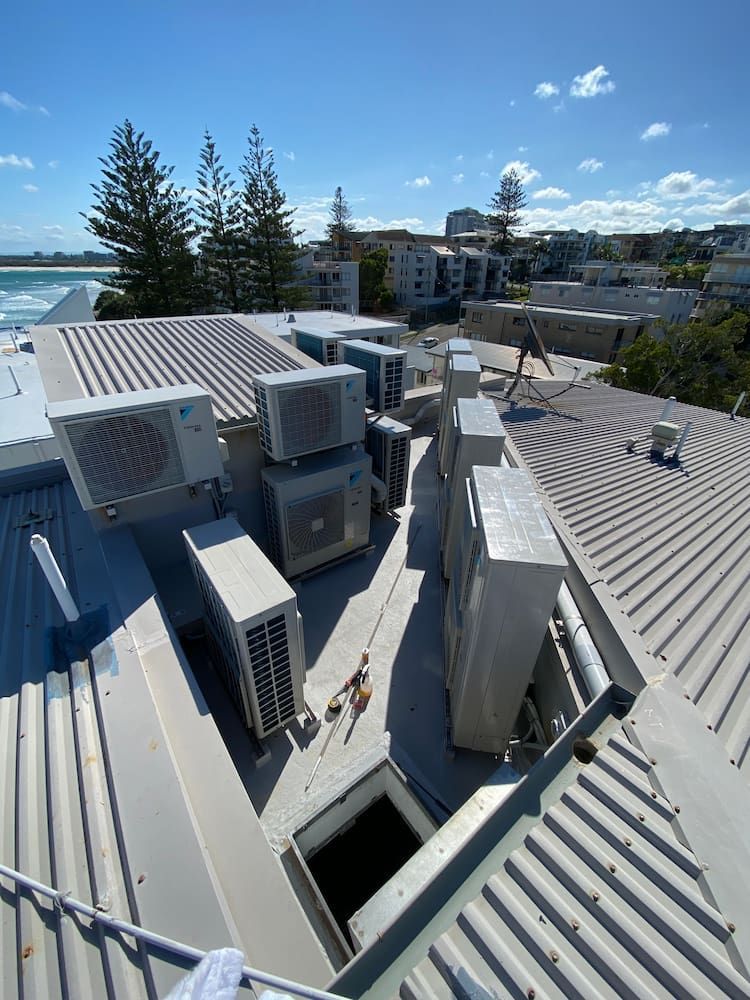 A Bunch of Condenser Unit at the Top of the Roof — Comfort Solutions in Caloundra, QLD
