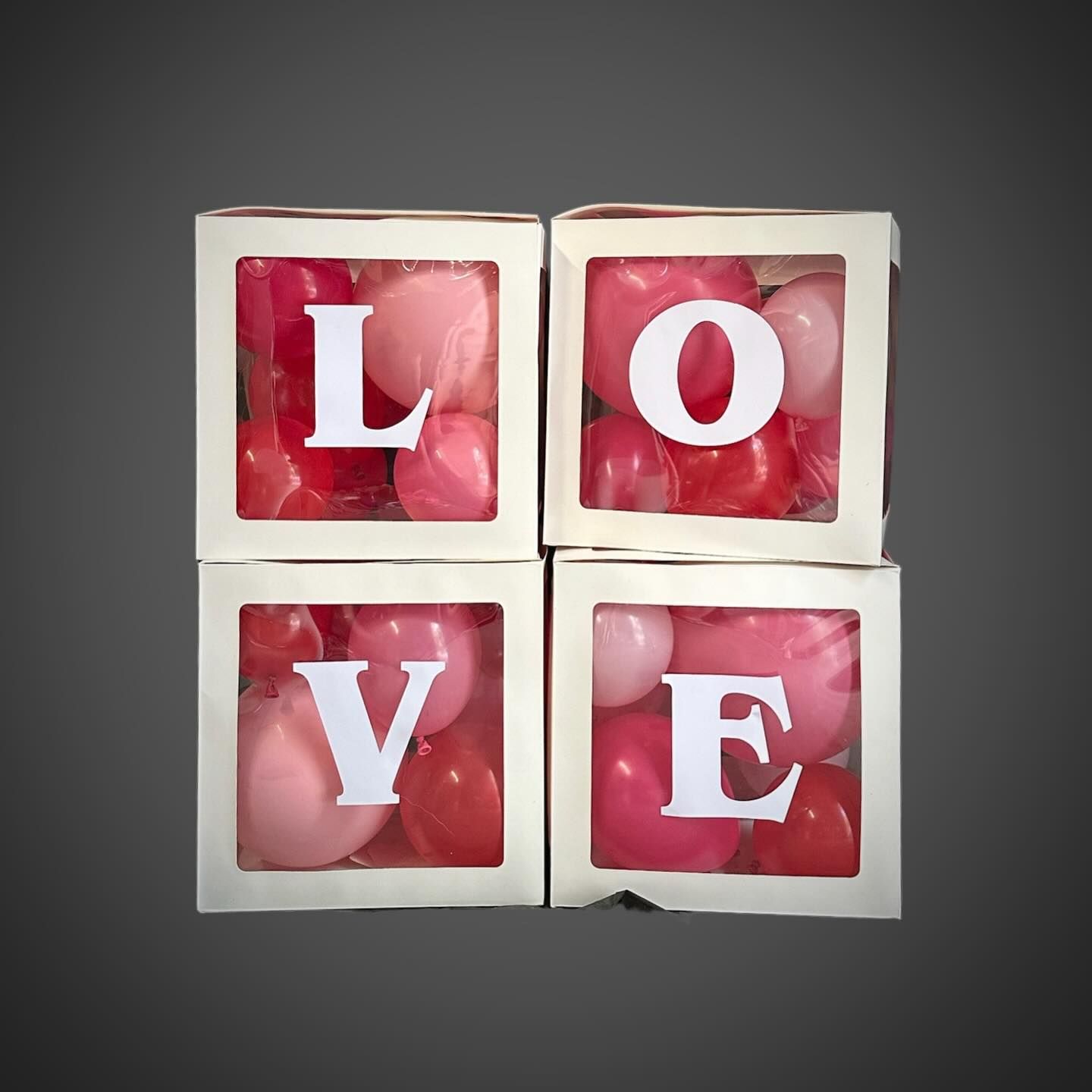 Four boxes with the word love on them filled with pink balloons — Yeppoon Balloons & Party Supplies in Yeppoon, QLD