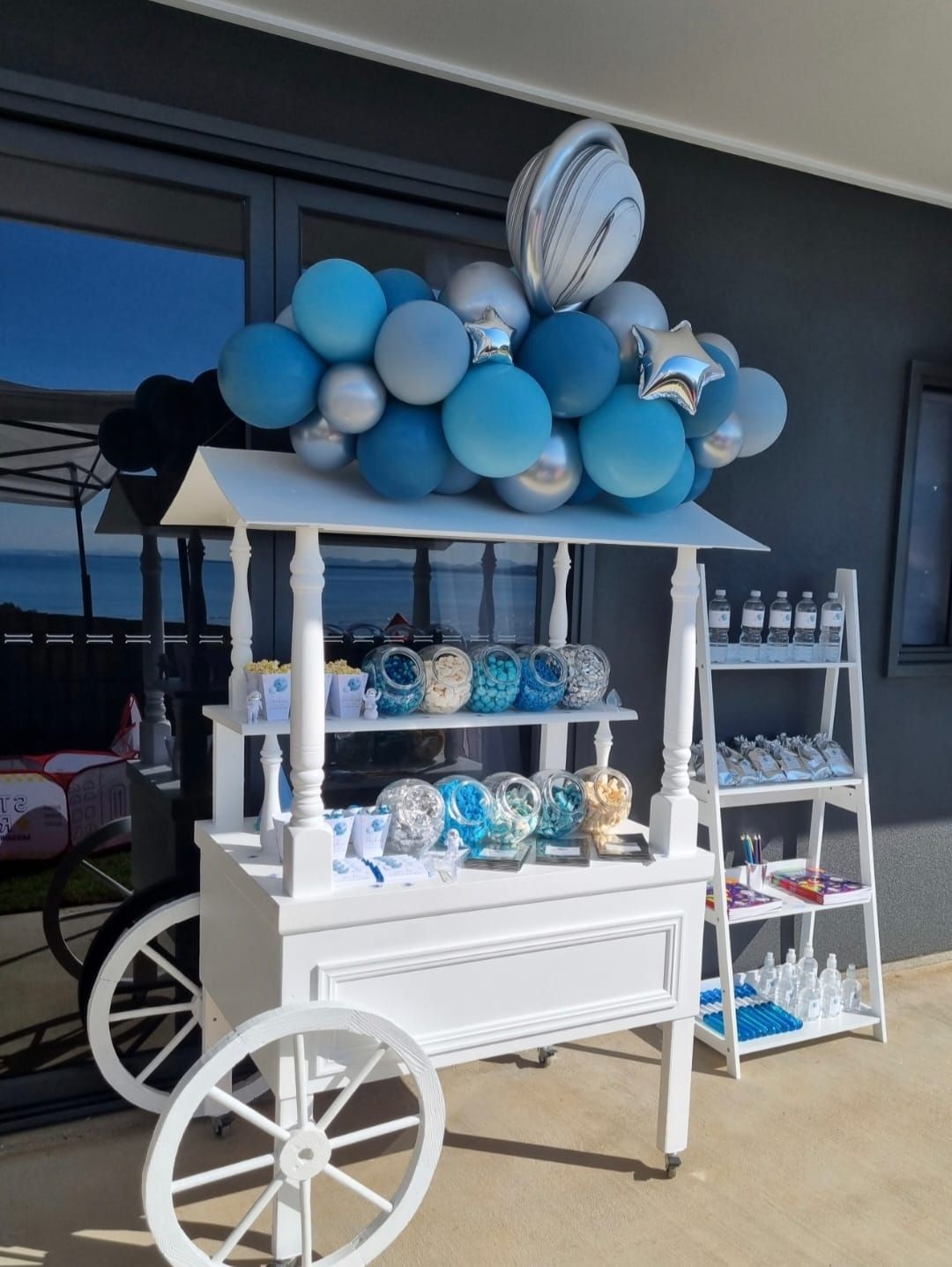 A White Cart With Blue and Silver Balloons on Top of It — Yeppoon Balloons & Party Supplies in Yeppoon, QLD