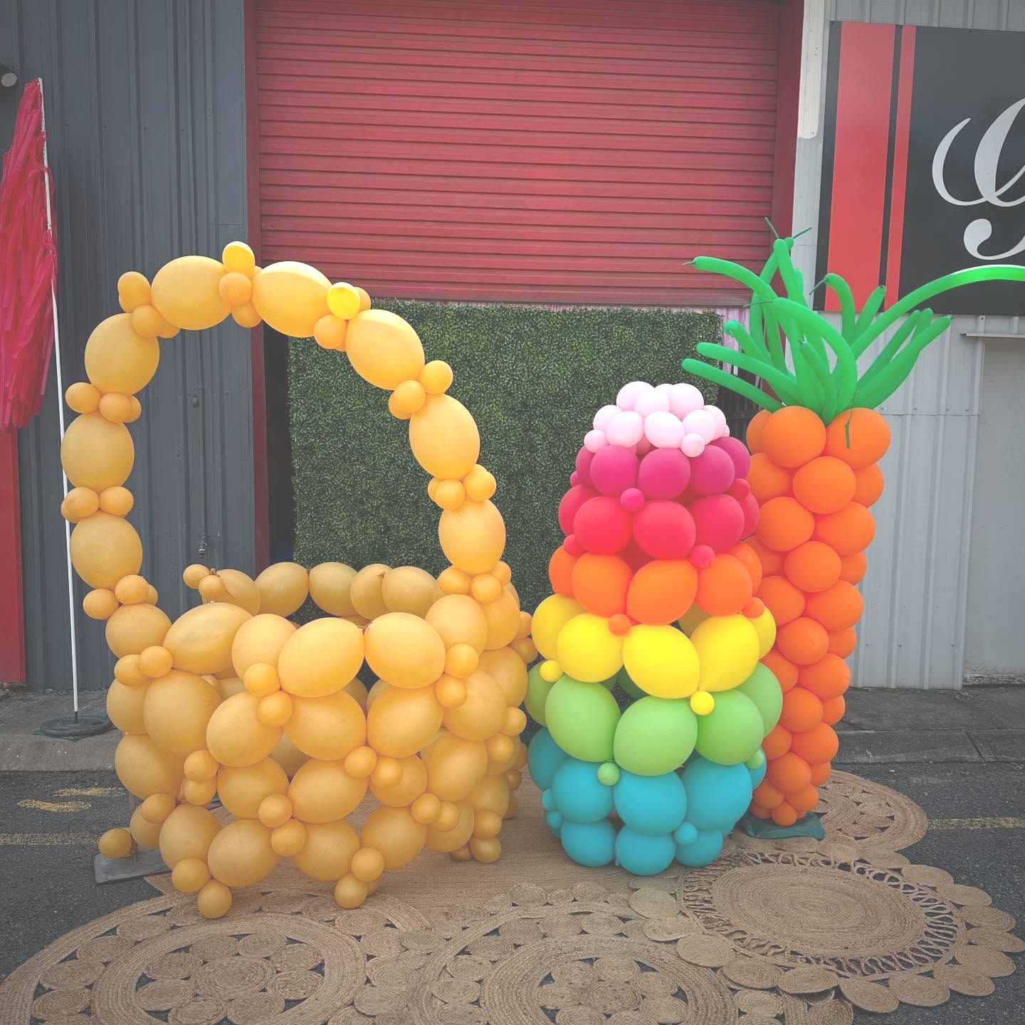 A Birthday Cake Made Out of Red Yellow and Blue Balloons — Yeppoon Balloons & Party Supplies in Yeppoon, QLD