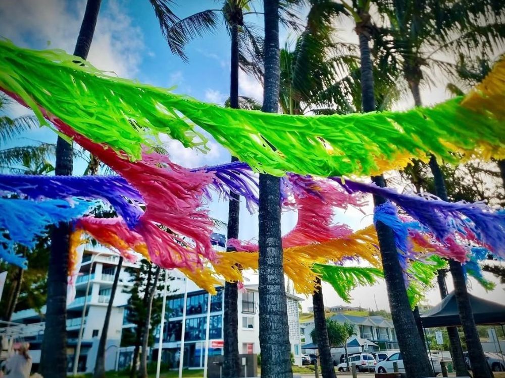 A Bunch of Colourful Streamers Are Hanging From Palm Trees - Yeppoon Balloons & Party Supplies in Yeppoon, Qld