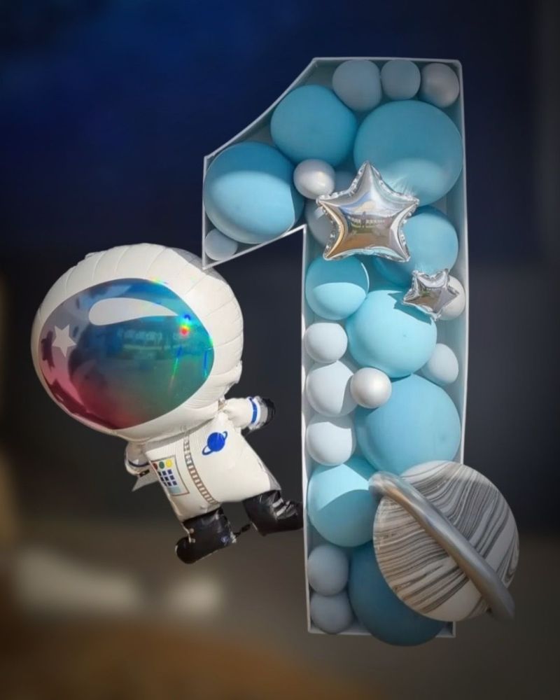 A Balloon in the Shape of an Astronaut Is Sitting Next to a Number One Made of Balloons - Yeppoon Balloons & Party Supplies in Yeppoon, Qld