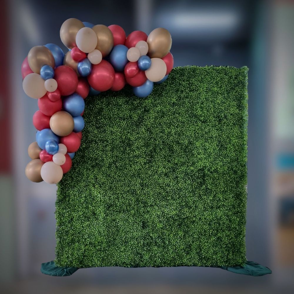 Tropical greenery wall with balloons attached