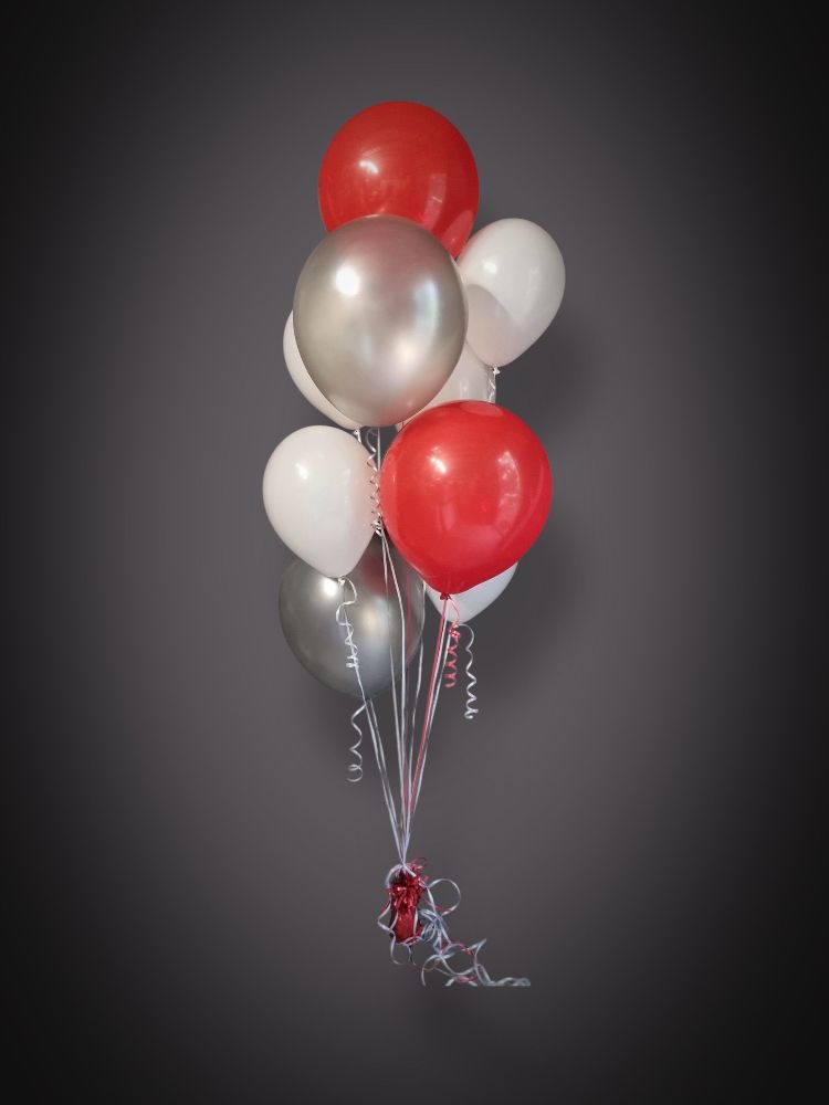 Bundle of Helium filled latex balloons in the colours red, silver and white