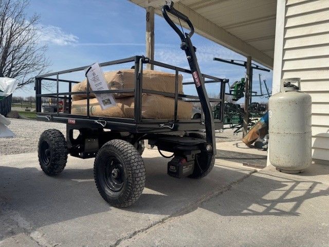 Close up of rugged wheels of an electric utility cart moving over muddy terrain