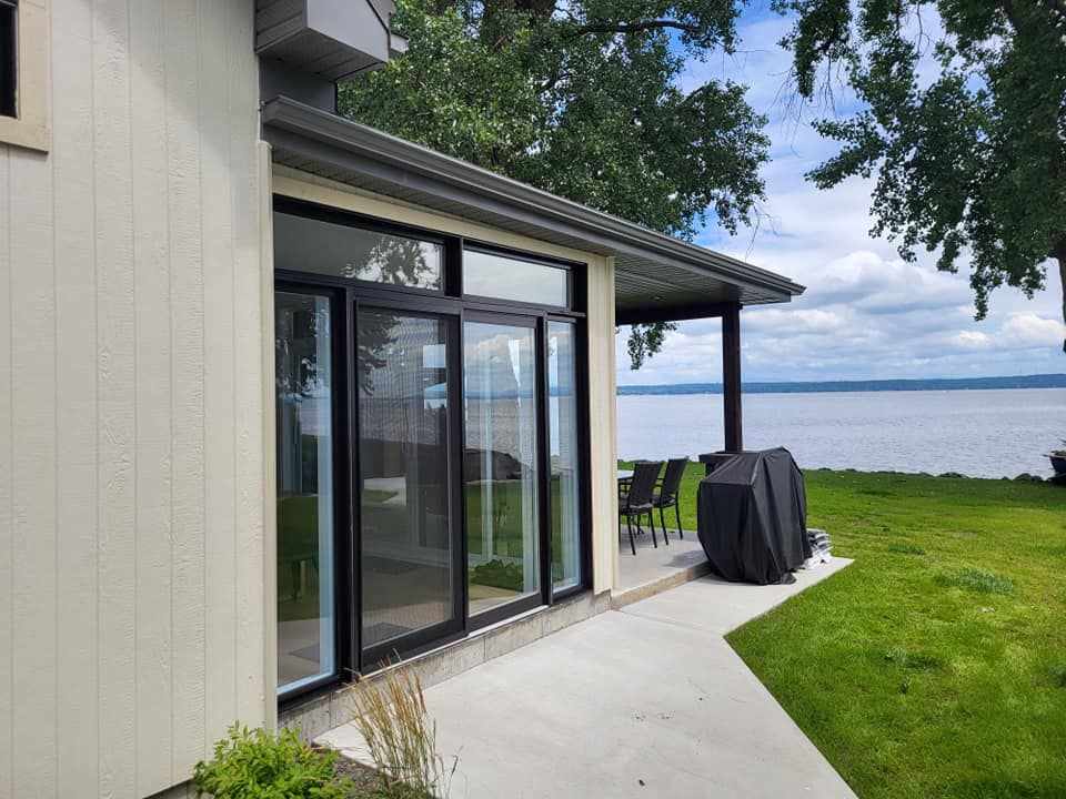 Une maison avec un patio et une vue sur l'eau.