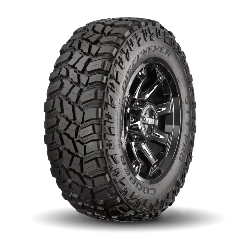 Black off-road tire on a dark alloy wheel; rugged tread pattern.