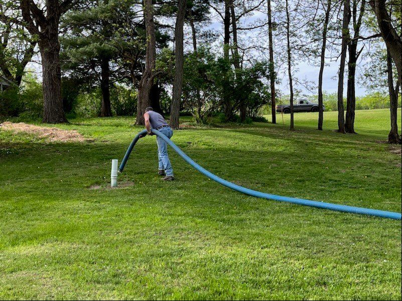 Man Holding Pipe To Clean Septic Tank — Poynette, WI — Elsing Septic Service