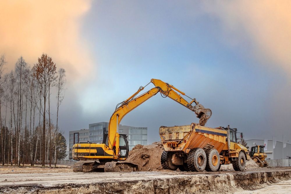 View a digger and dumper truck on a brownfield site in the construction industry. Construction equipment.