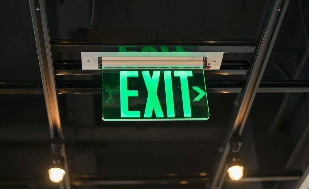 Egress exit sign in red and white marking emergency way out in commercial building