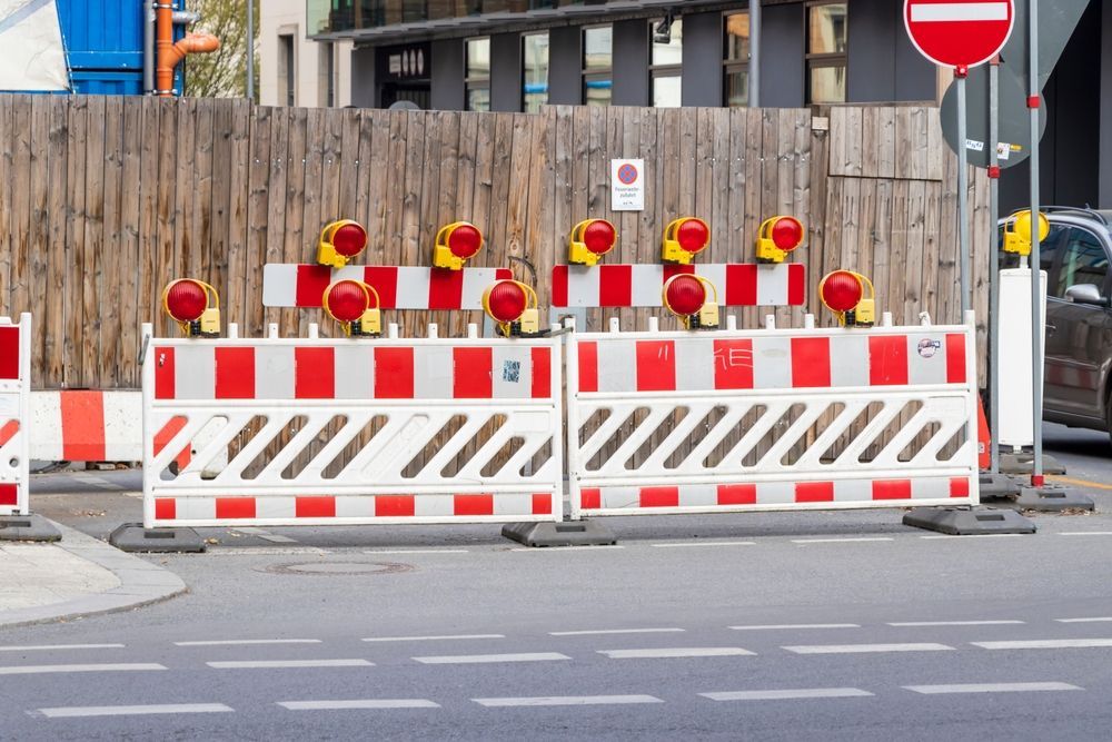 Traffic control plan with barriers and warning lights blocking city street for construction safety