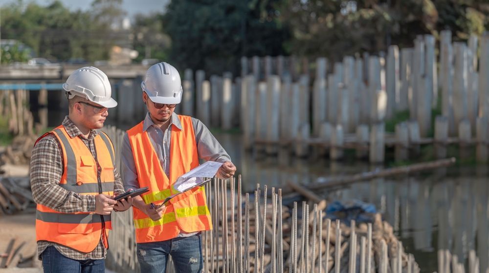 Demolition permit inspection with construction engineer and foreman supervising work at active jobsite