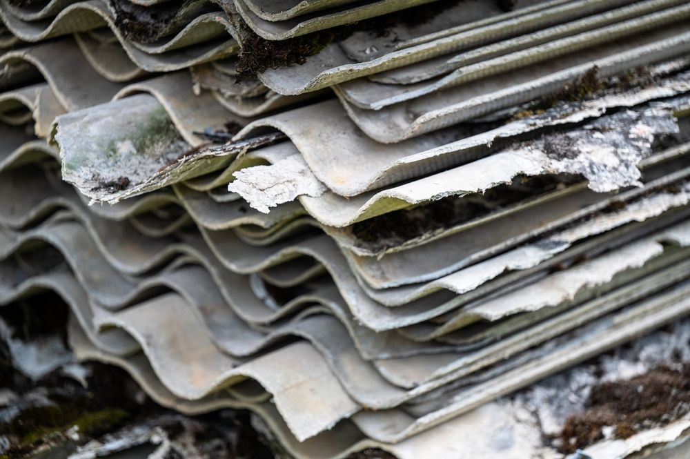 A pile of asbestos sheets stacked on top of each other.