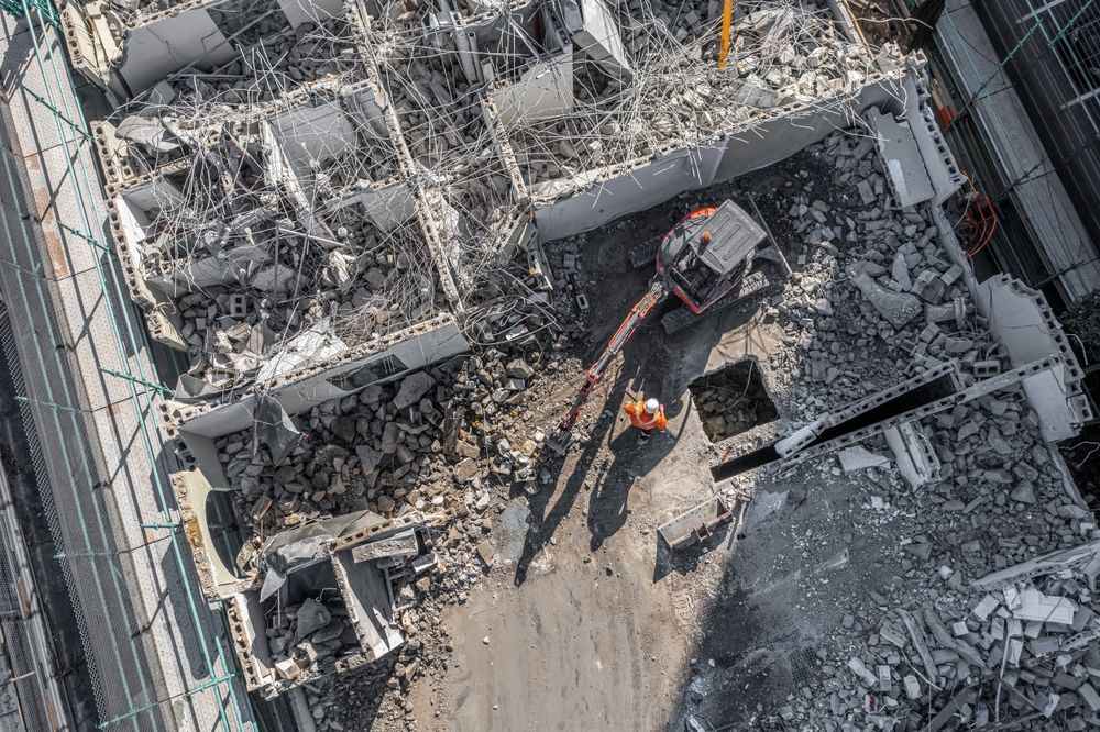 An aerial view of a building being demolished.