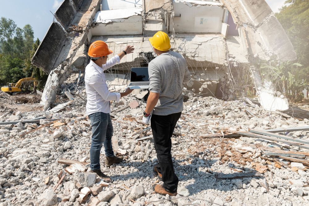 professional demolition team talking through a demolition project onsite