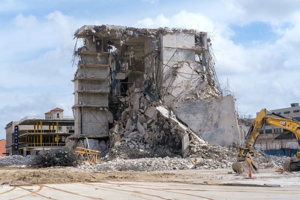 A large building is being demolished by a bulldozer.