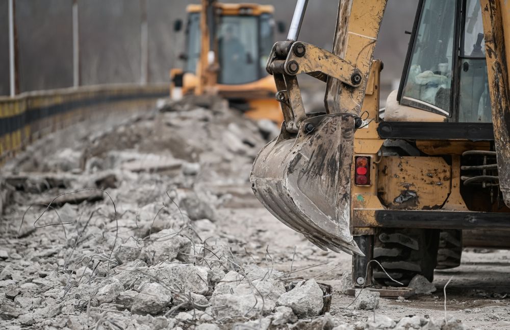 A bulldozer is digging a hole in the ground at a construction site.