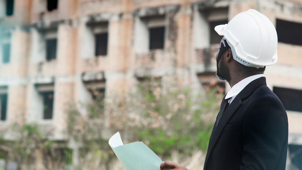An engineer is checking the demolition plans for construction.