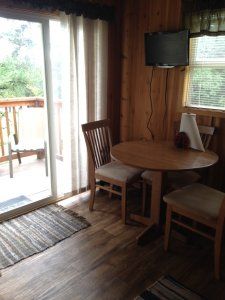 there is a table and chairs in the room with a sliding glass door .