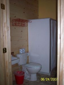 a bathroom with a toilet , sink , and shower .