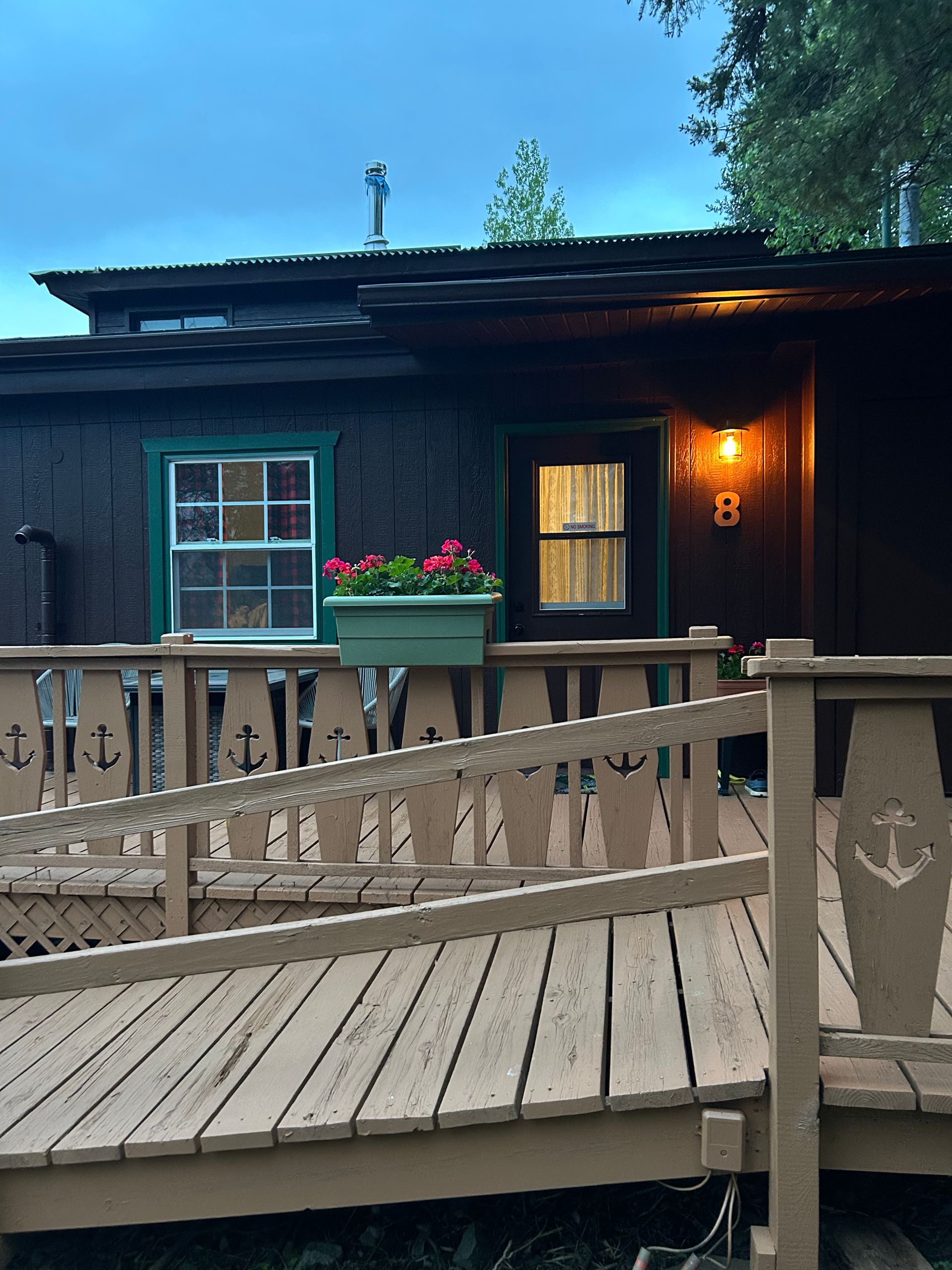 a living room with two beds , a couch , a television and a fireplace .