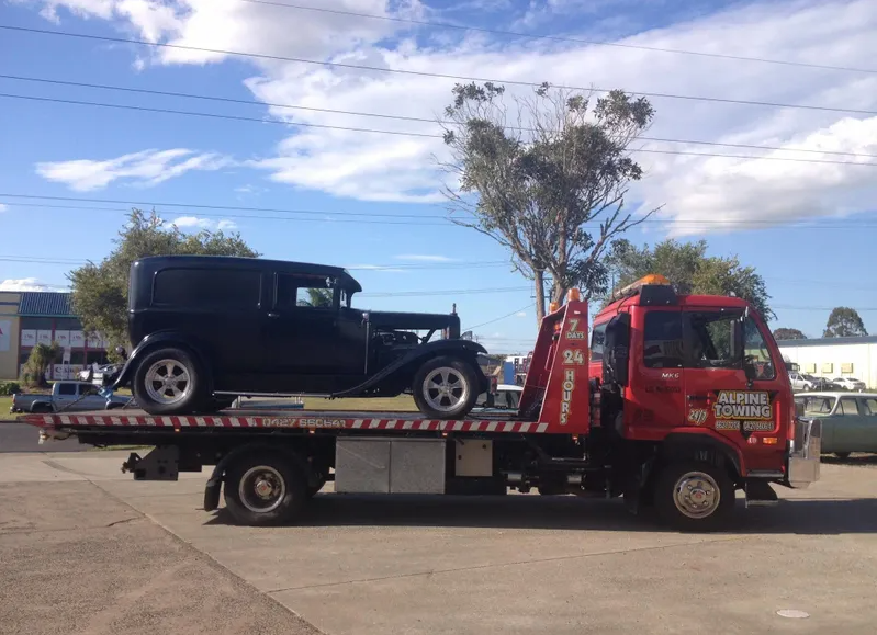 Car Being Towed onto Flatbed Tow Truck — Alpine Towing Services in Lismore, NSW